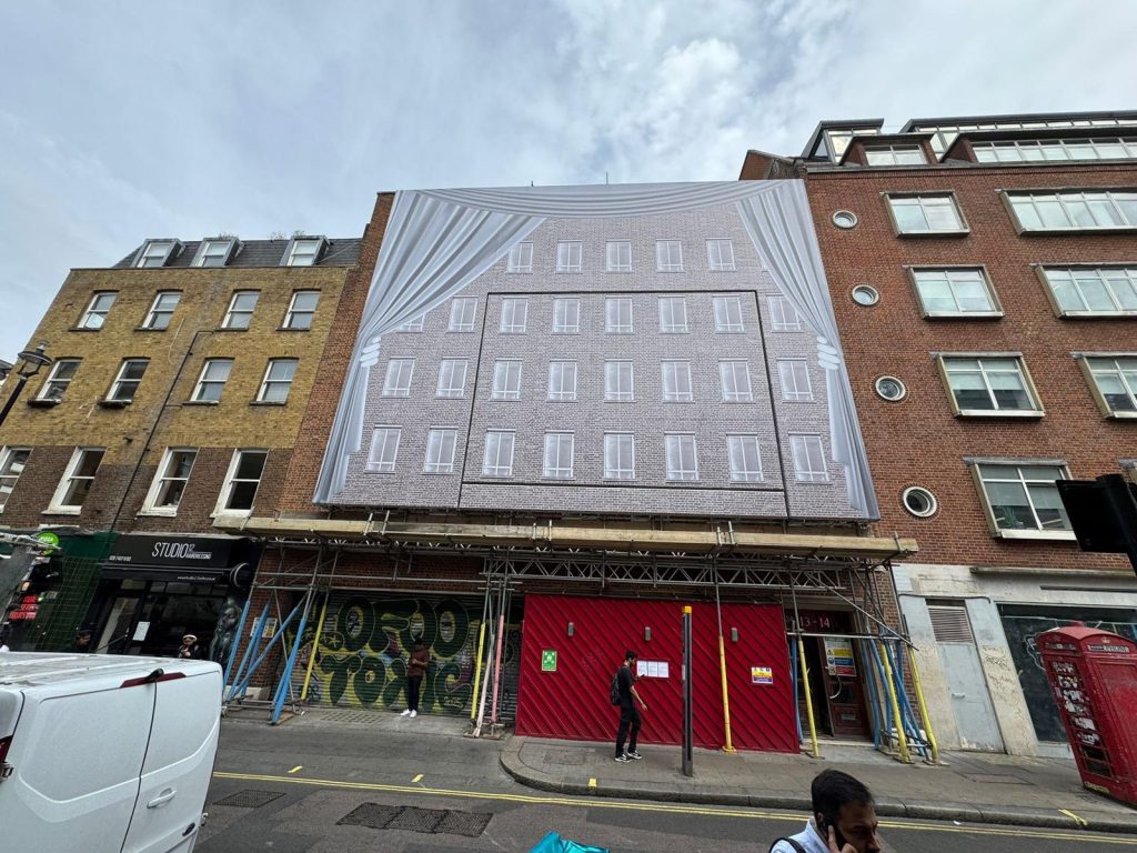 Scaffolding in Westminster London with advertising cover on Dean Street project by Aron Scaffolding.